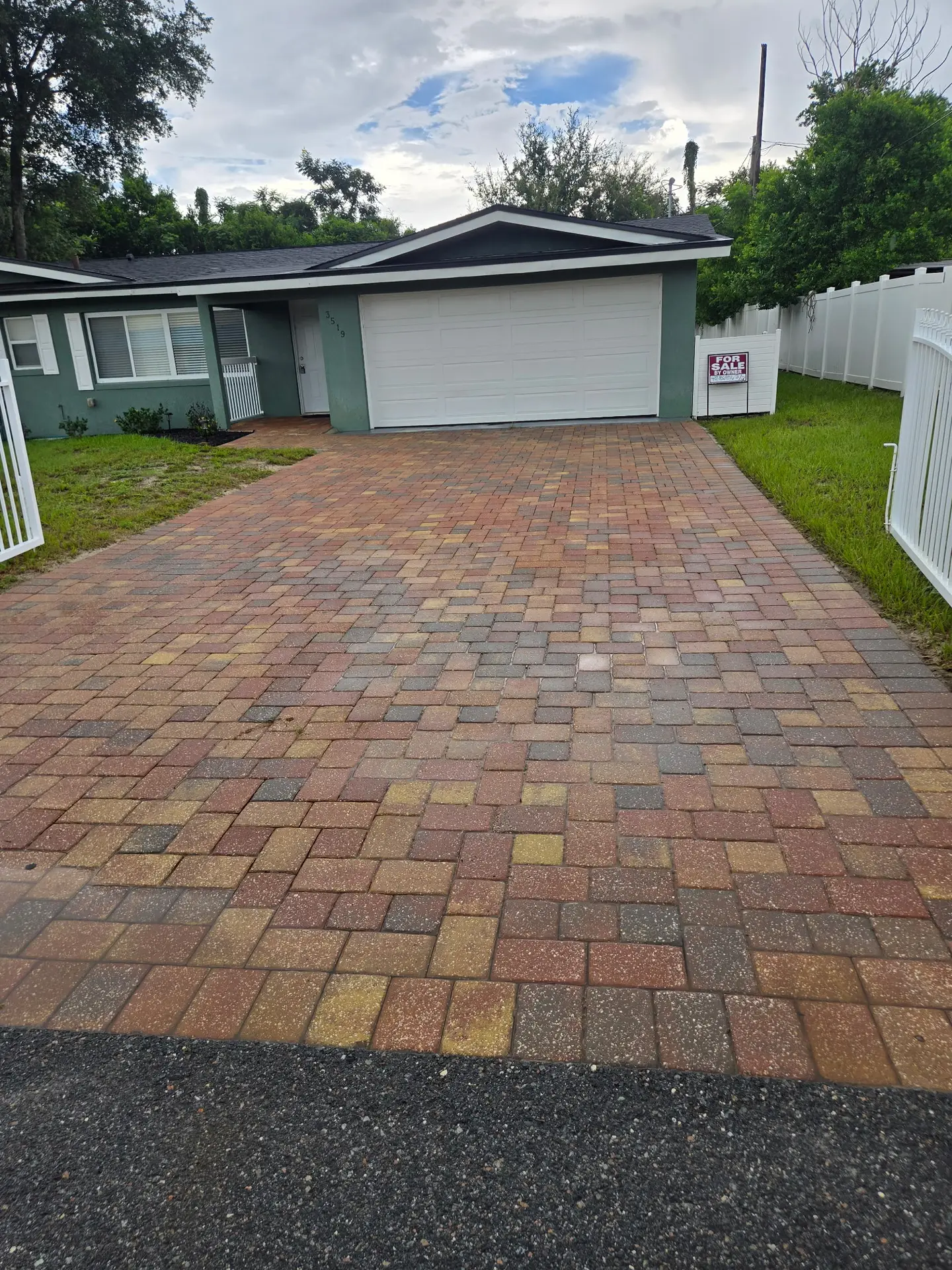 The same paver driveway cleaned to a bright, even finish after paver cleaning in Mount Dora FL