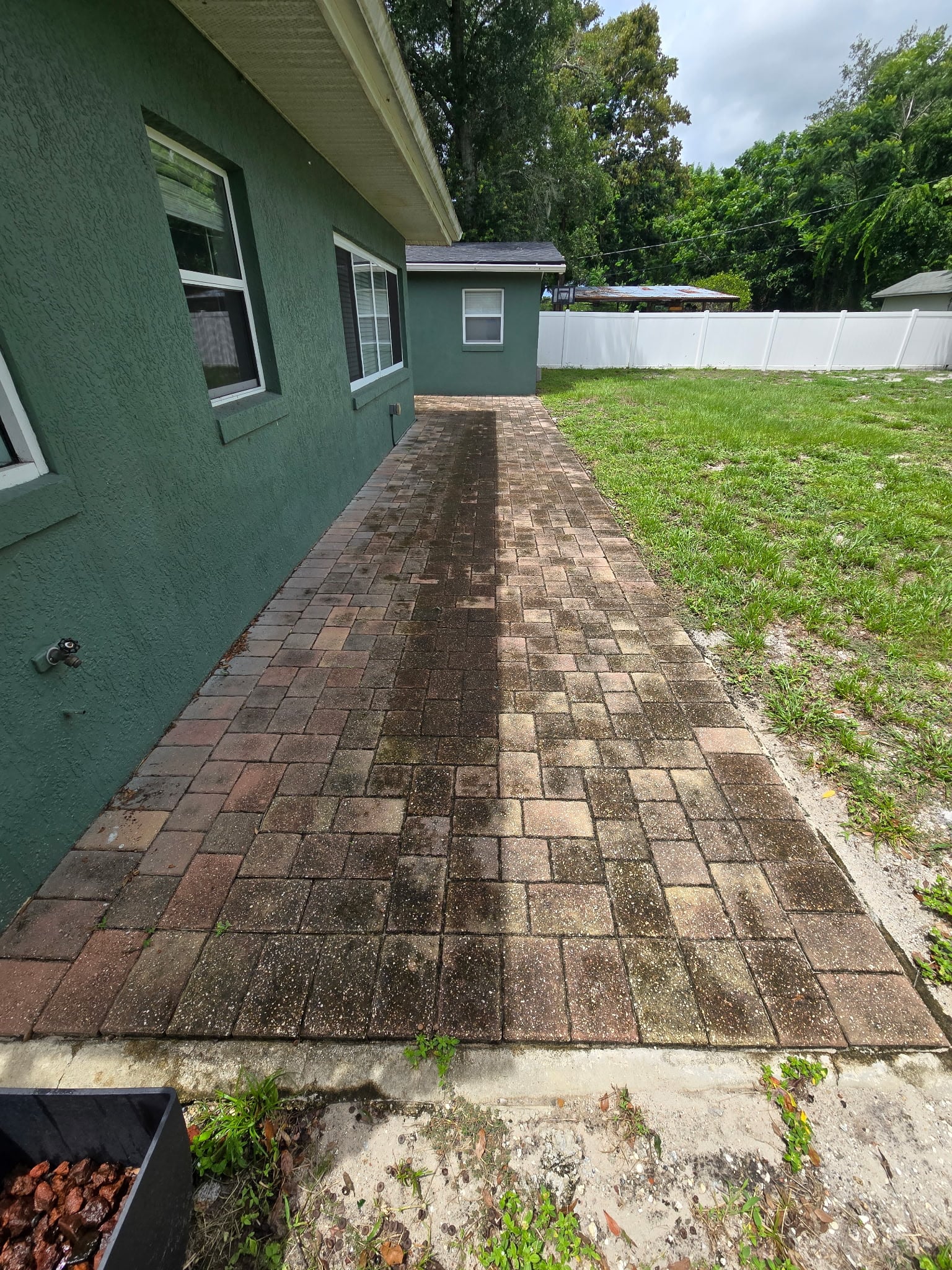 Paver side walkway dulled by algae and dirt before paver cleaning in Mount Dora FL