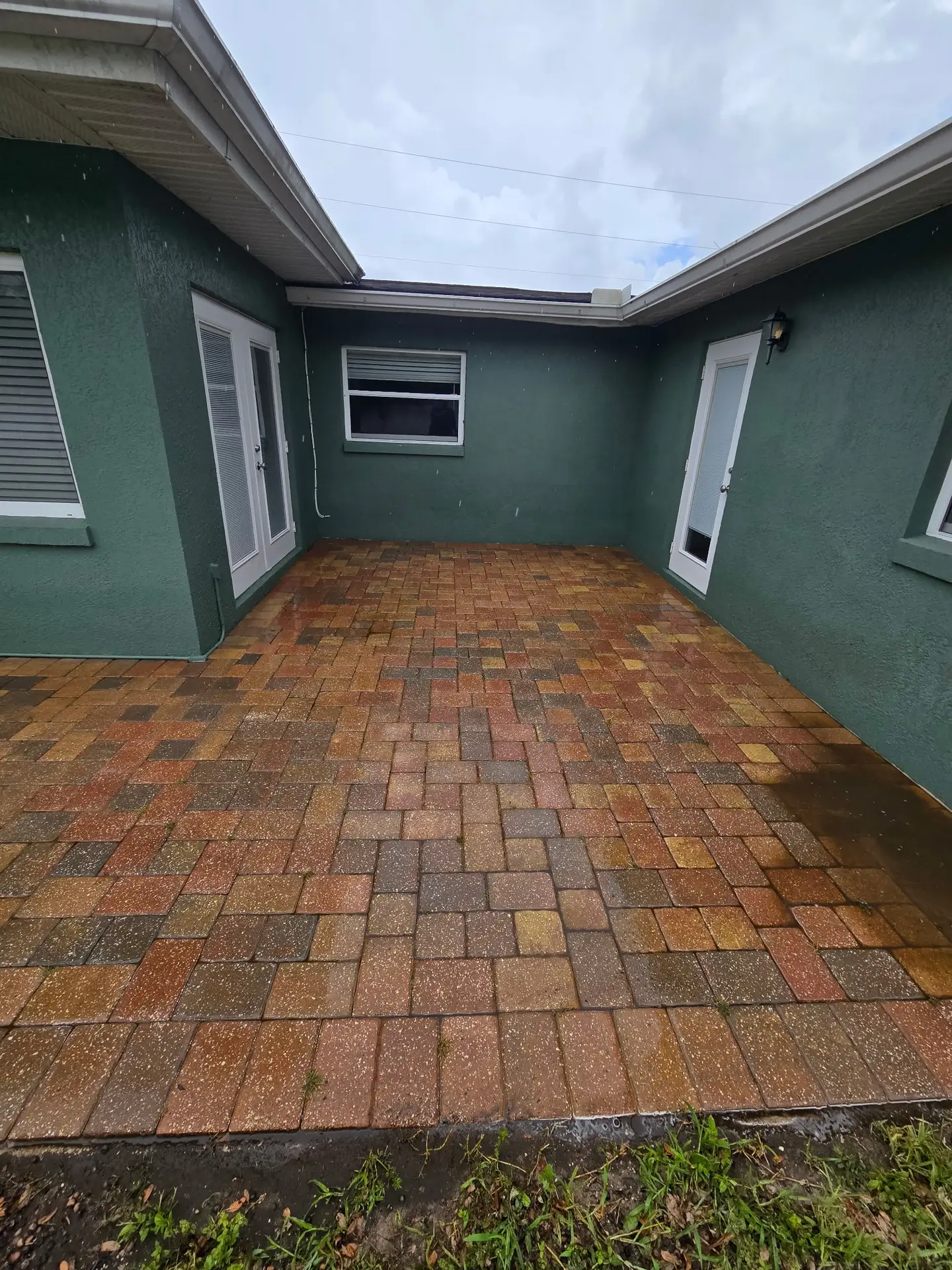 The same paver courtyard cleaned back to bare paver color after paver cleaning in Mount Dora FL